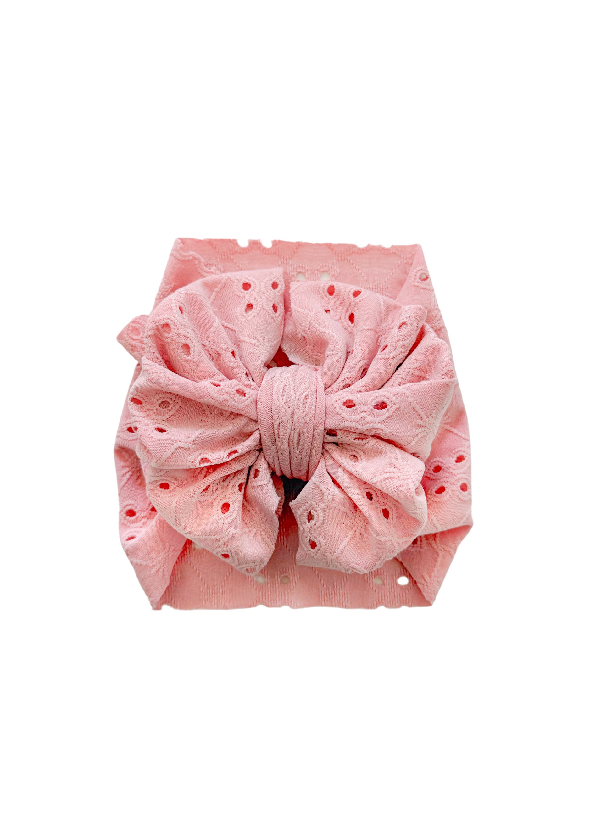 Eyelet baby bow in blush.
