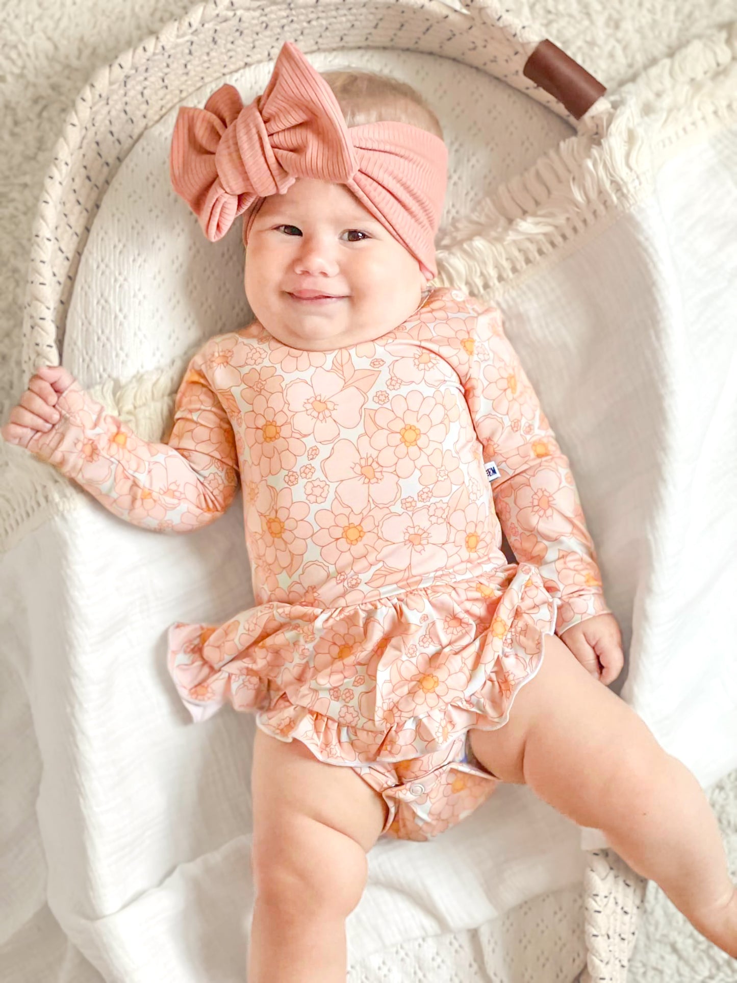 Baby wearing a floral bamboo twirl dress.