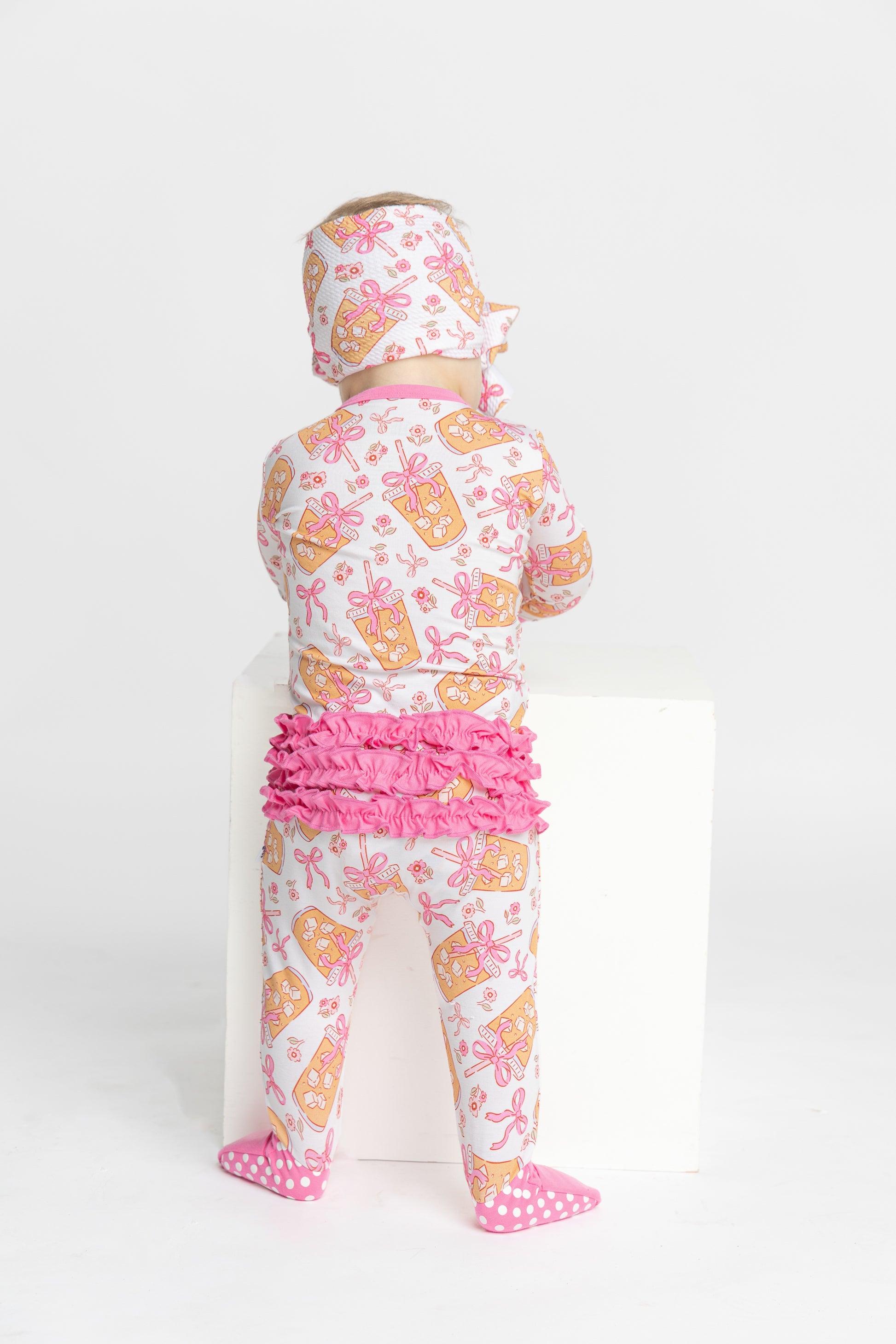 Bows and coffee bamboo convertible footie romper for baby with ruffle detail.