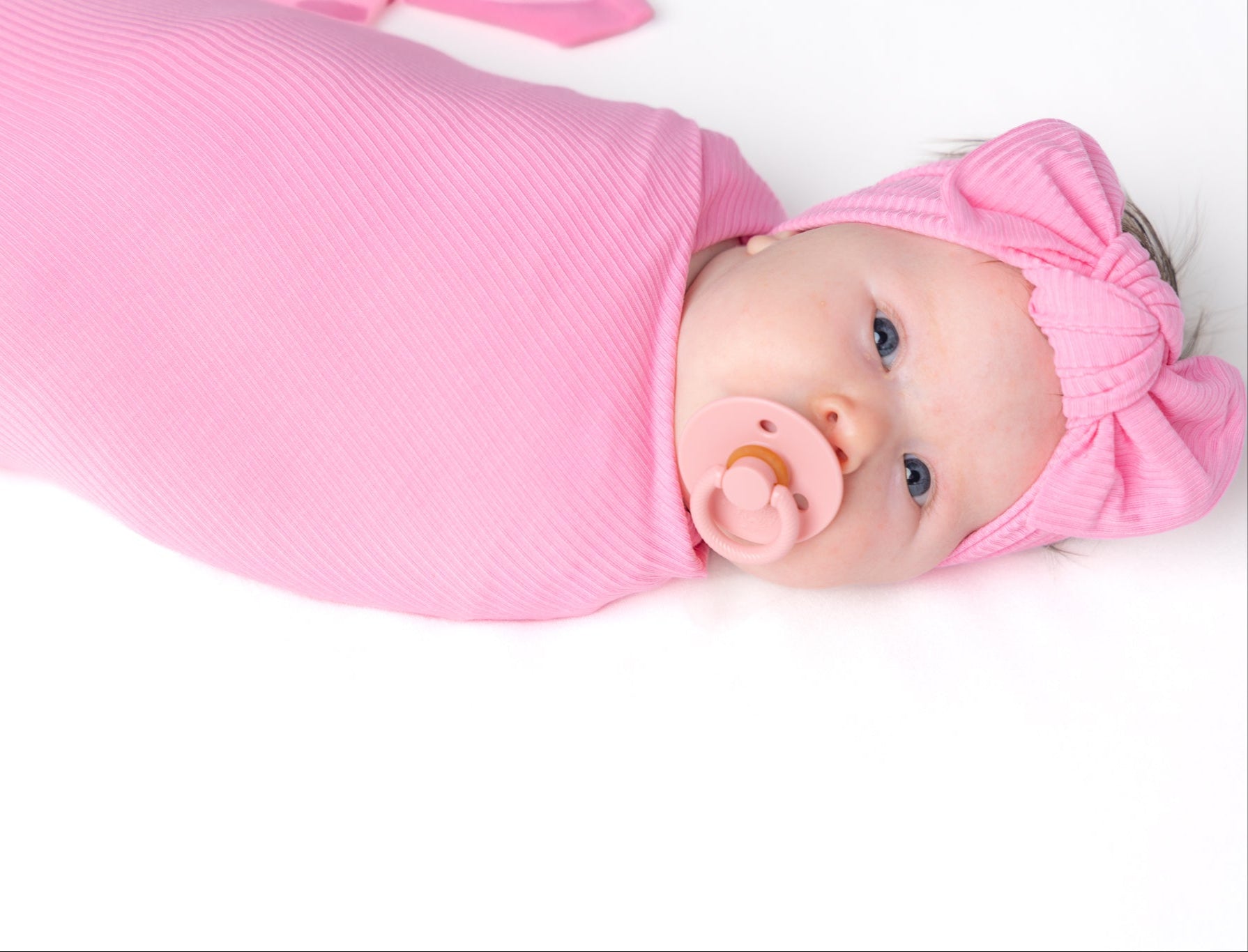 Pink bamboo swaddle blanket for baby.