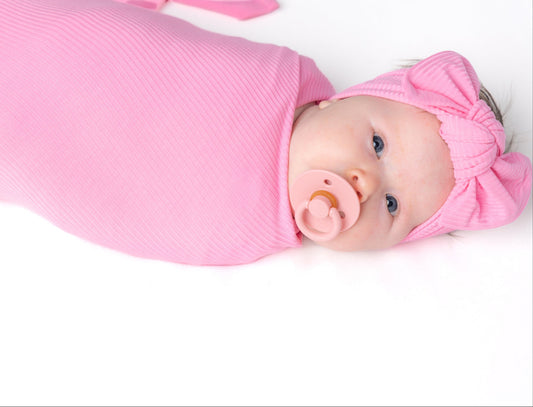 Pink bamboo swaddle blanket for baby.
