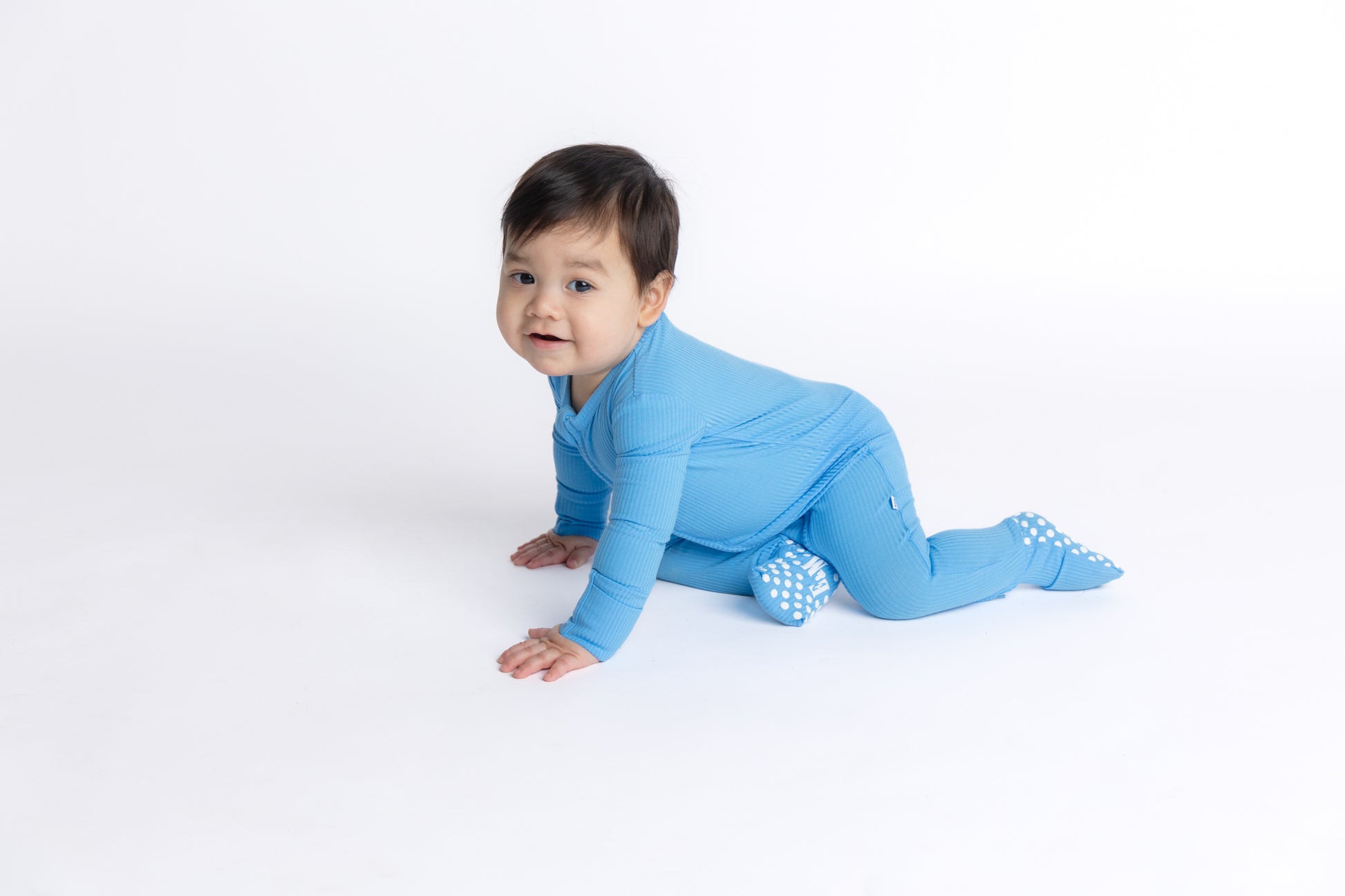 Blue ribbed bamboo convertible sleeper footie for newborns, made with soft, breathable, and eco-friendly bamboo fabric for ultimate comfort and easy changing. Perfect for your little one!