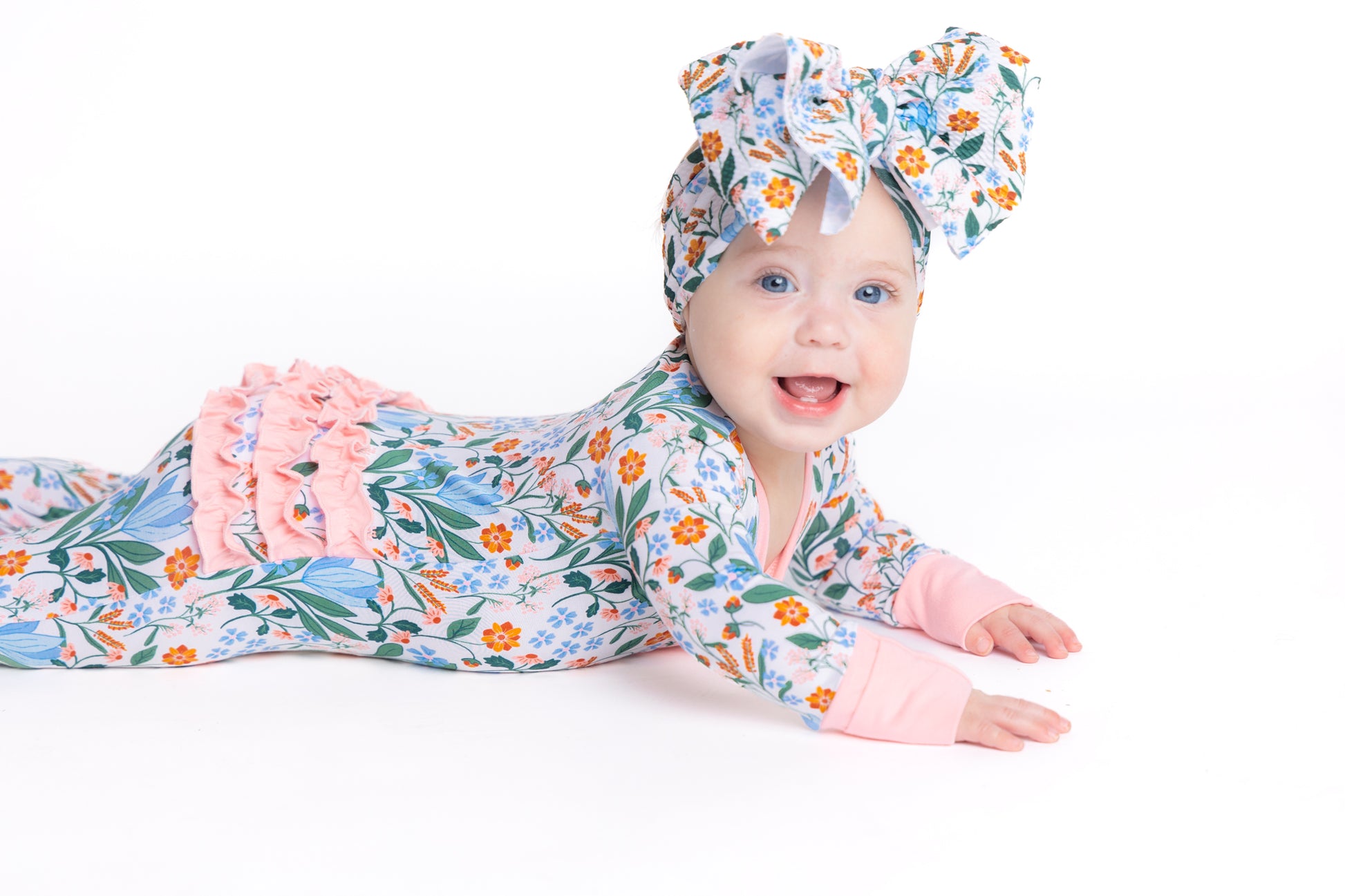 Shop our bamboo baby sleeper with a double zipper in a blue and pink spring floral print. Eco-friendly and breathable for easy changes and all-day comfort.