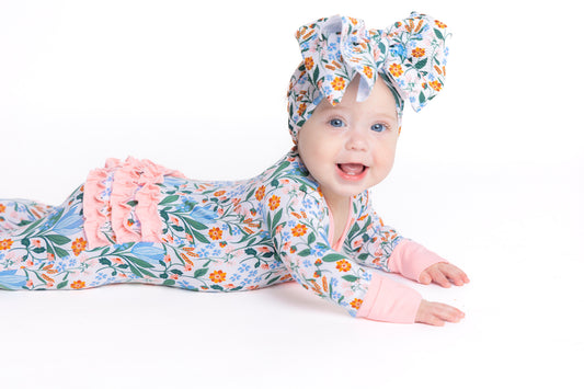 Shop our bamboo baby sleeper with a double zipper in a blue and pink spring floral print. Eco-friendly and breathable for easy changes and all-day comfort.