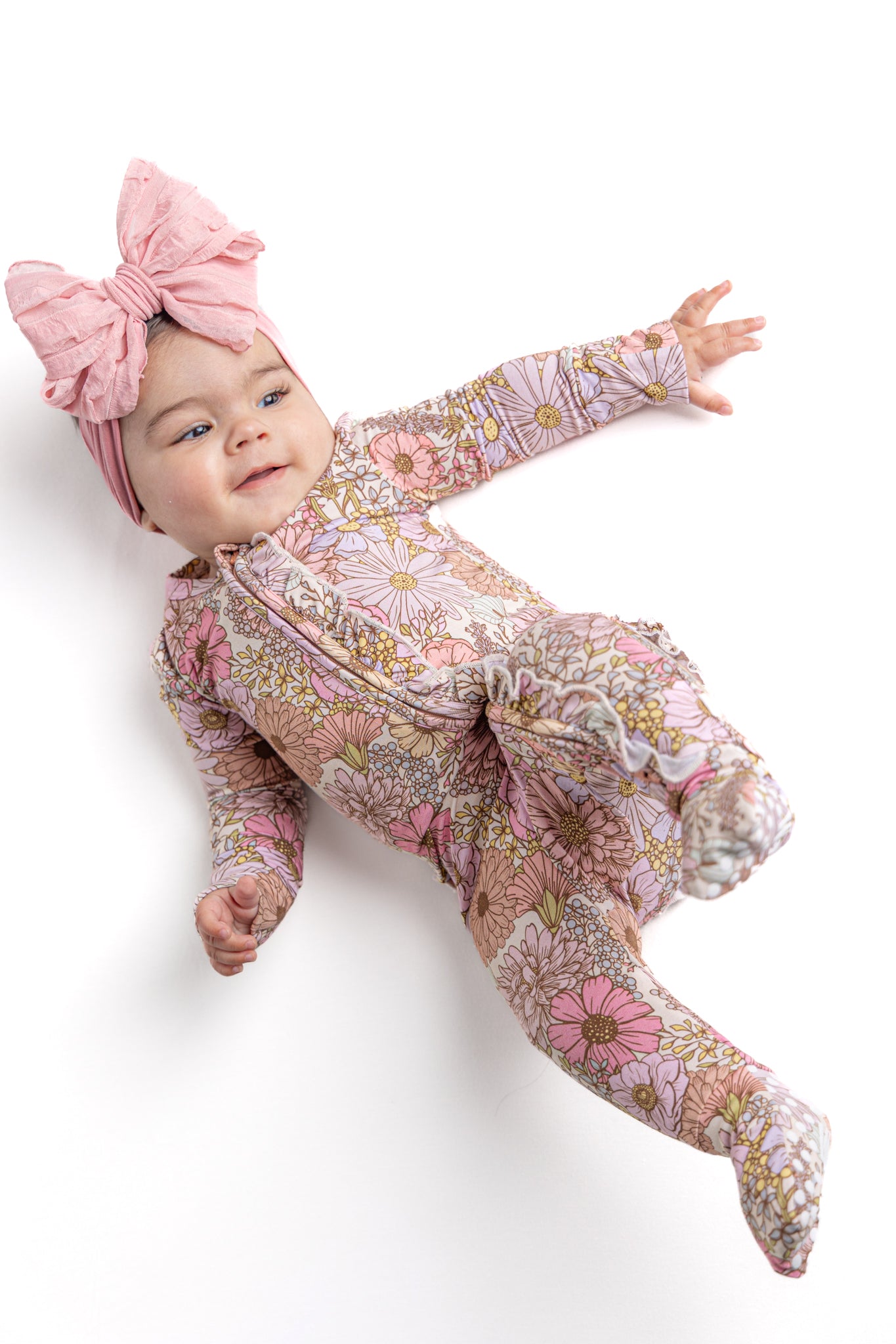 Baby wearing floral bamboo convertible double zipper pajamas.