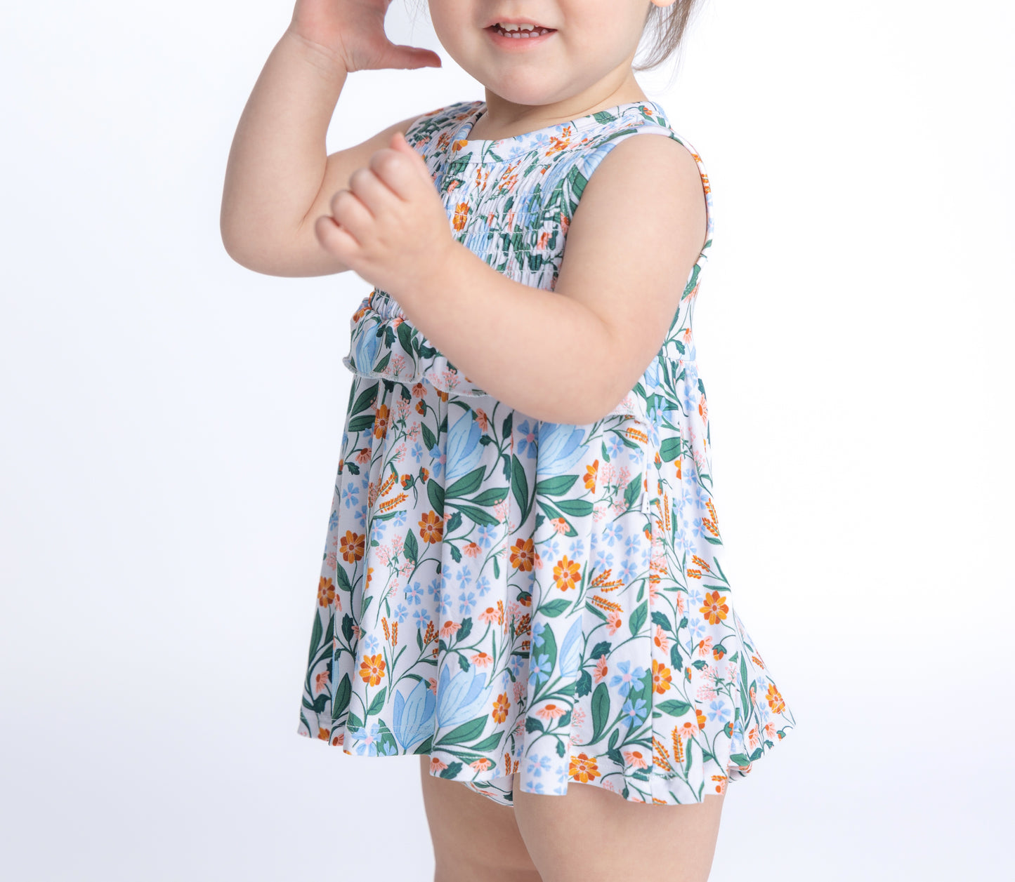 Shop our bamboo smocked onesie dress in a blue and pink spring floral print. Eco-friendly and breathable for all-day comfort.