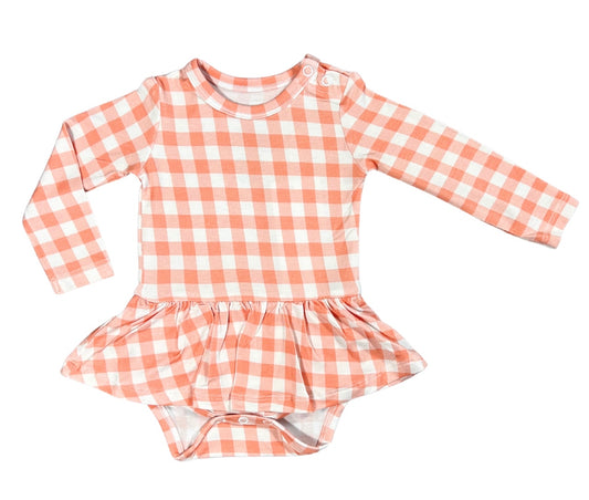 baby skirted bodysuit dress made of bamboo for ultimate softness and with a cute peach gingham print.