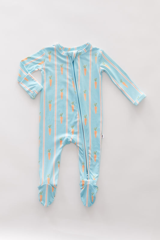 Baby onesie with carrot pattern on a light blue background