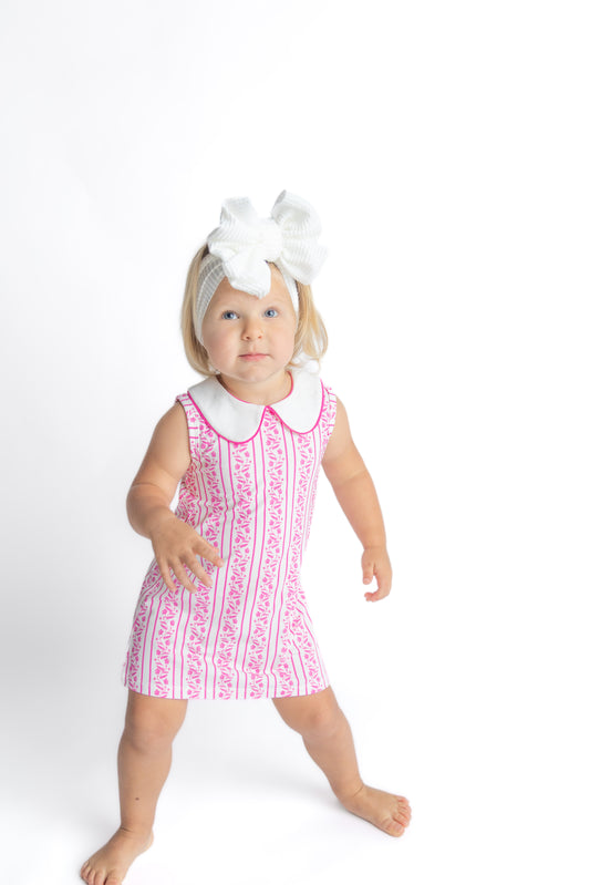 Toddler in pink floral dress made of soft viscose from bamboo fabric.