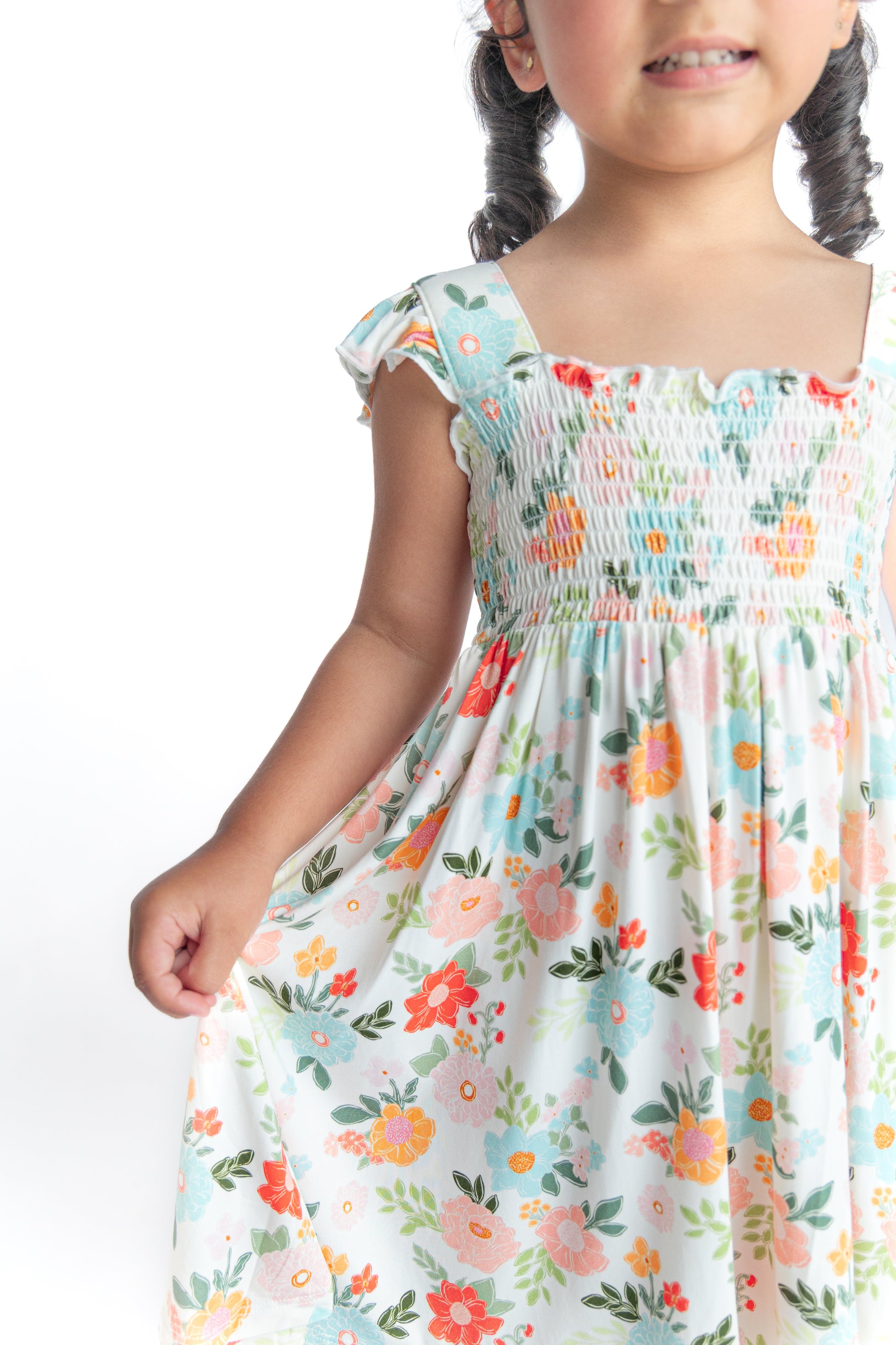 Girl wearing floral smocked twirl dress
