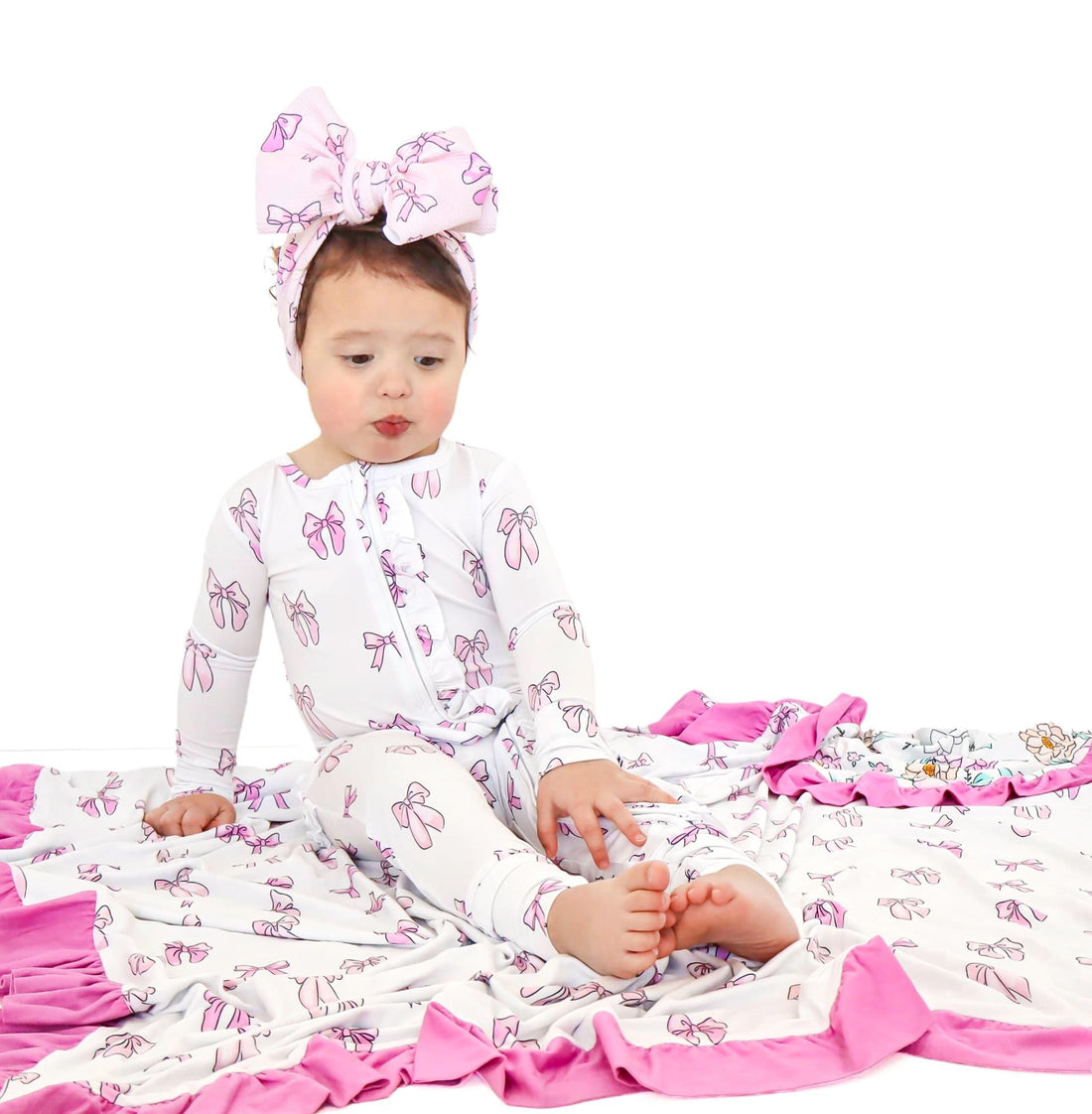 baby in bow print bamboo sleeper with blanket. 