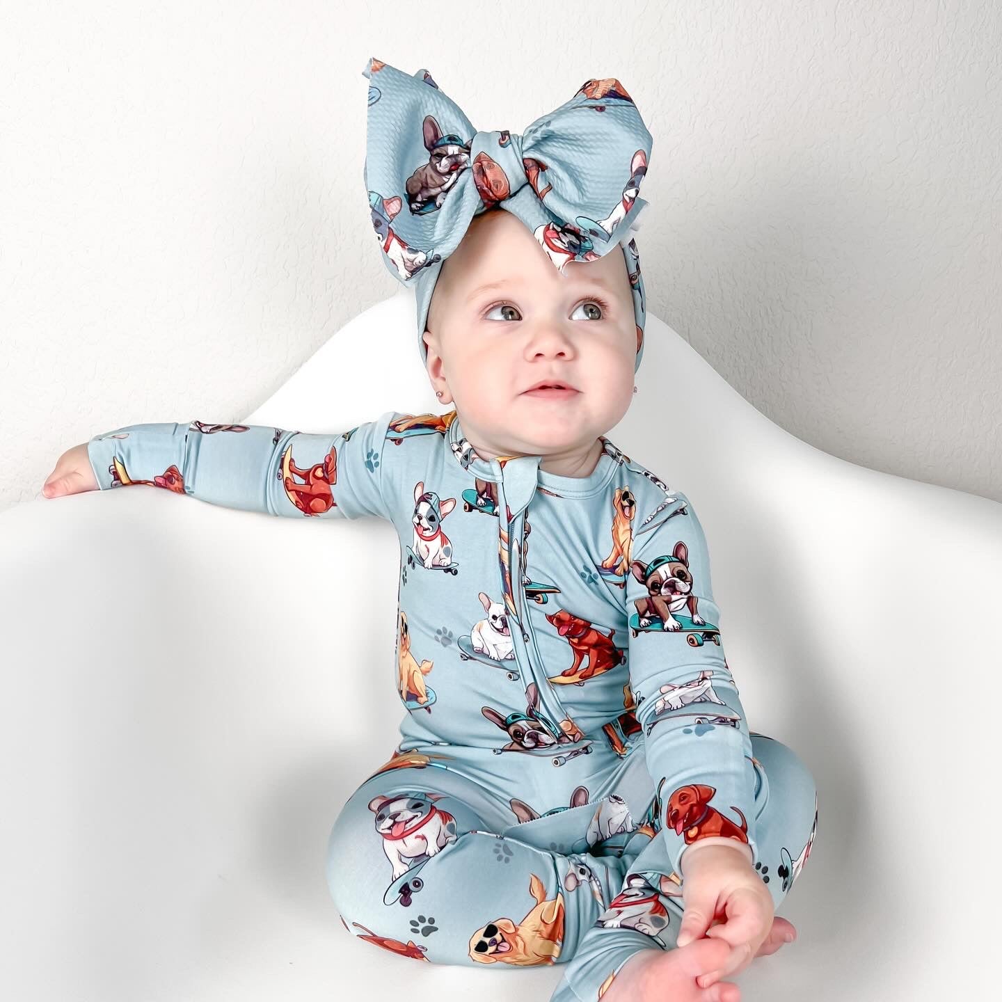 Dog print bamboo baby footie, featuring a double zipper for easy diaper changes and convertible cuffs! 