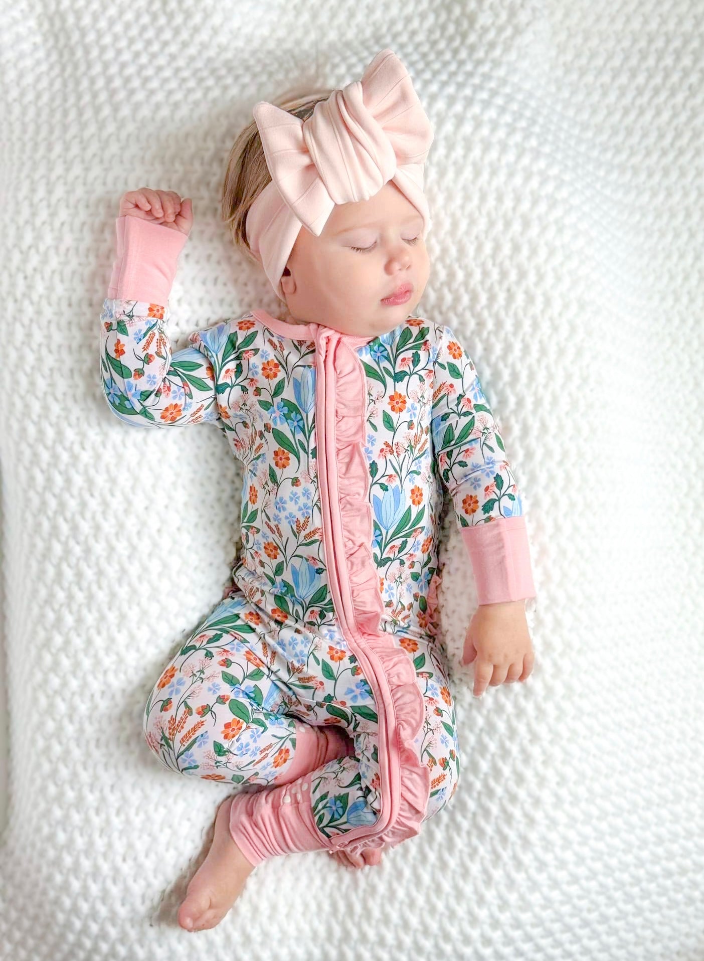 Shop our bamboo baby sleeper with a double zipper in a soft blue and pink spring floral print. Made from breathable, eco-friendly fabric for comfort and easy changes. 