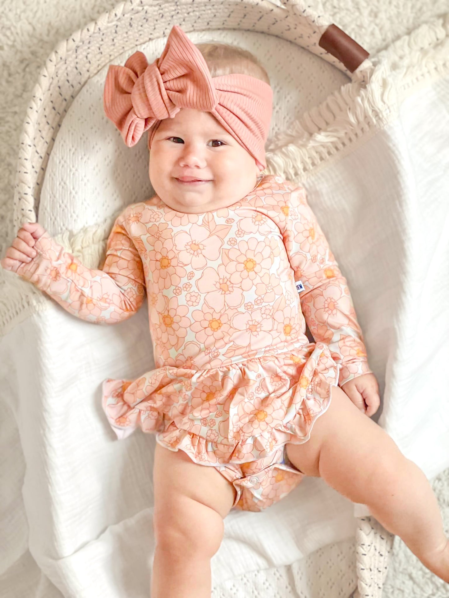 Baby wearing a floral bamboo twirl dress. 