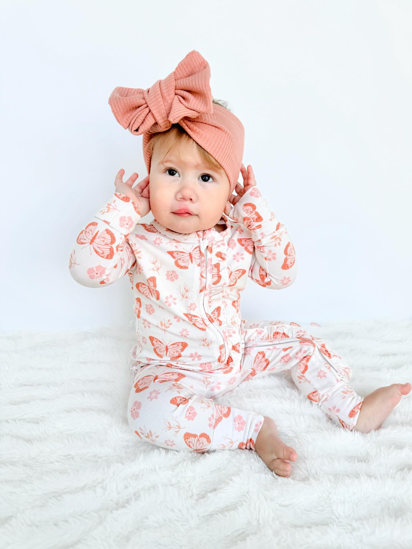 Baby girl bamboo pajama footie featuring a butterfly floral print. Soft and cozy baby bamboo.