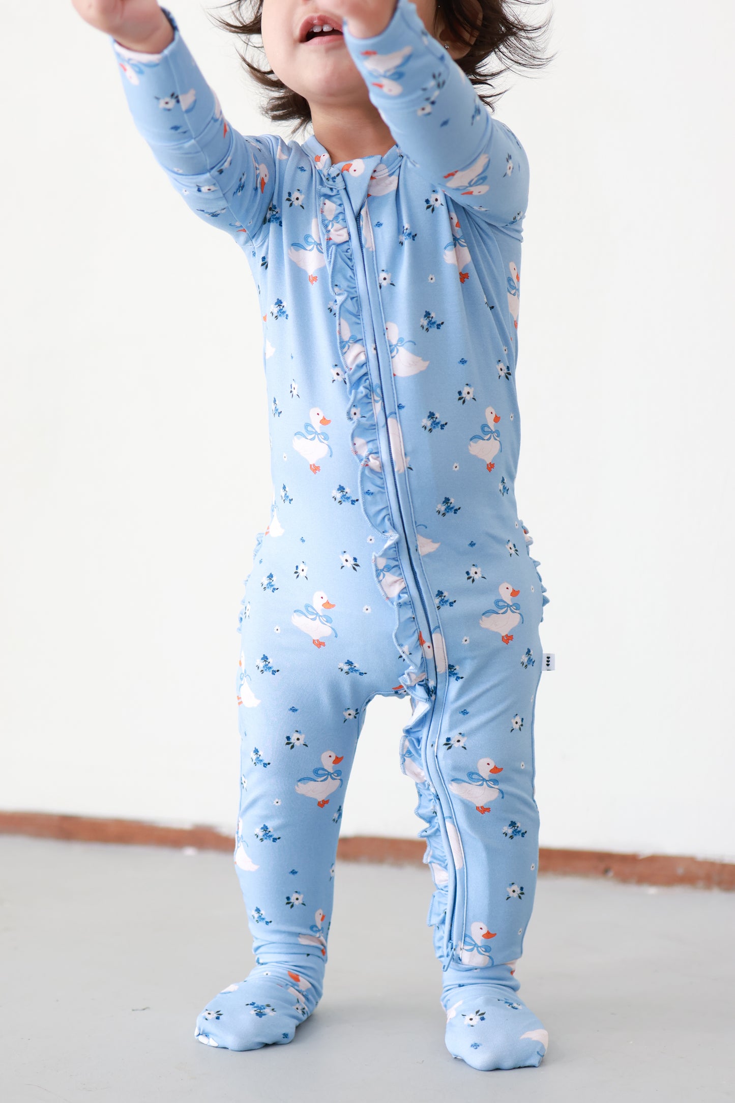 girl wearing blue duck print bamboo sleeper