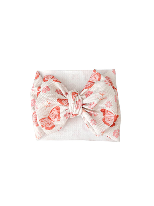 Baby girl headwrap bow with a dainty butterfly and floral print. Perfect accessory to complete the look. 