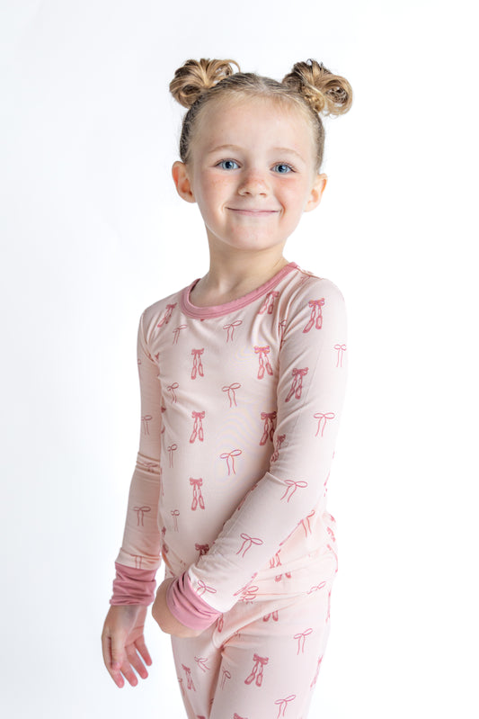Smiling girl in ballet and bow bamboo pajamas