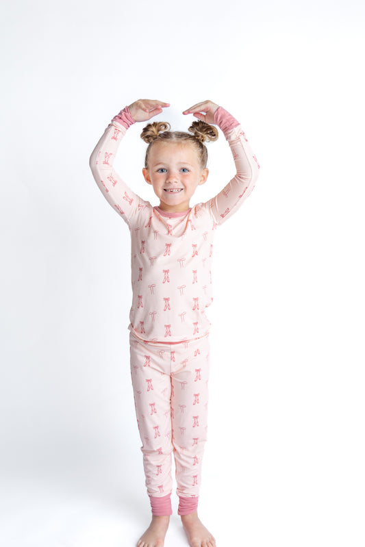 Girl in bamboo ballet pajamas with dainty bows. 