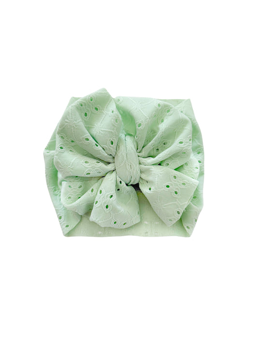 Baby girl headwrap bow in mint eyelet fabric. 