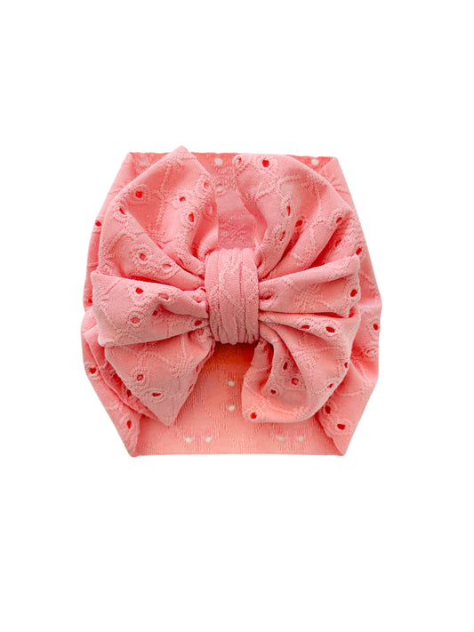 Newborn eyelet headwrap bow in pink. Perfect for summer. 