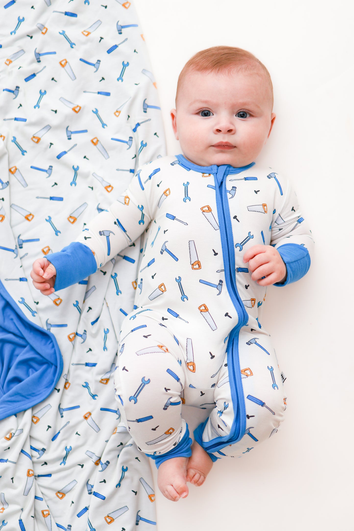 Baby boy wearing Elle & Mily Tool Time bamboo convertible zip romper