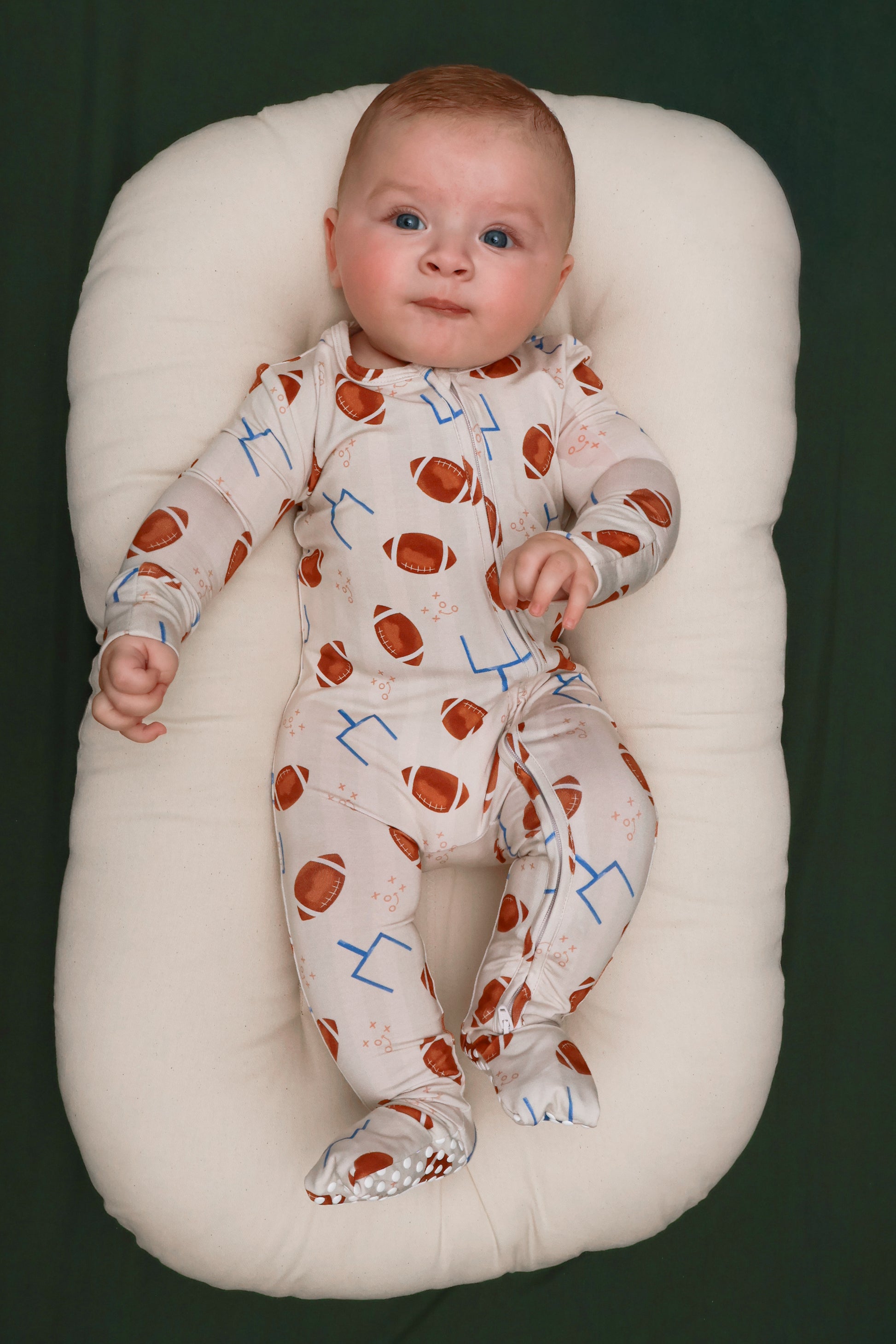 Baby wearing Elle & Mily Touchdowns football print bamboo convertible zip romper